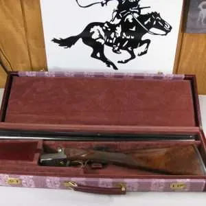 7897 winchester 23 grand canadian 20 gauge 26 barrels, in grand canadian case, ic/mod, straight grip, 100% original, ejectors, vent rib, single select trigger, gold raised maple leaf engraved on bottom of receiver, engraved coin silver receiver, aaa+++fancy feather crotch walnut, 99% condition, 2 ¾ and 3”, great shooter! don’t miss this one!